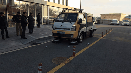 Autonomous road-sweeping vehicle moving during validation-scenario review